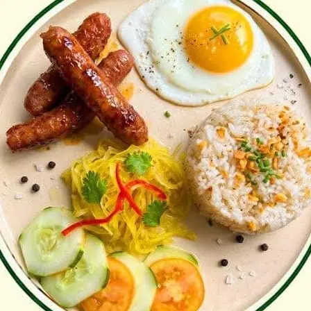 Longganisa with a fried egg, garlic rice, pickled papaya, cucumber and tomato.