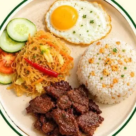 Beef tapa with a fried egg, garlic rice, pickled papaya, cucumber and tomato.