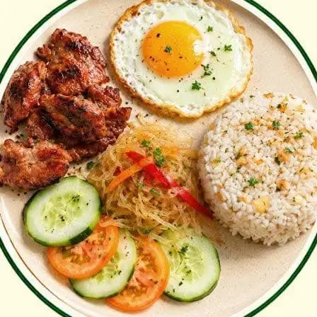 Tocino with a fried egg, garlic rice, pickled papaya, cucumber and tomato.