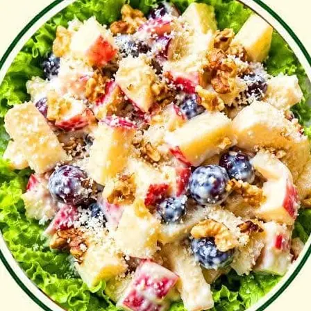 Waldorf salad of apple, grapes and walnuts on lettuce.